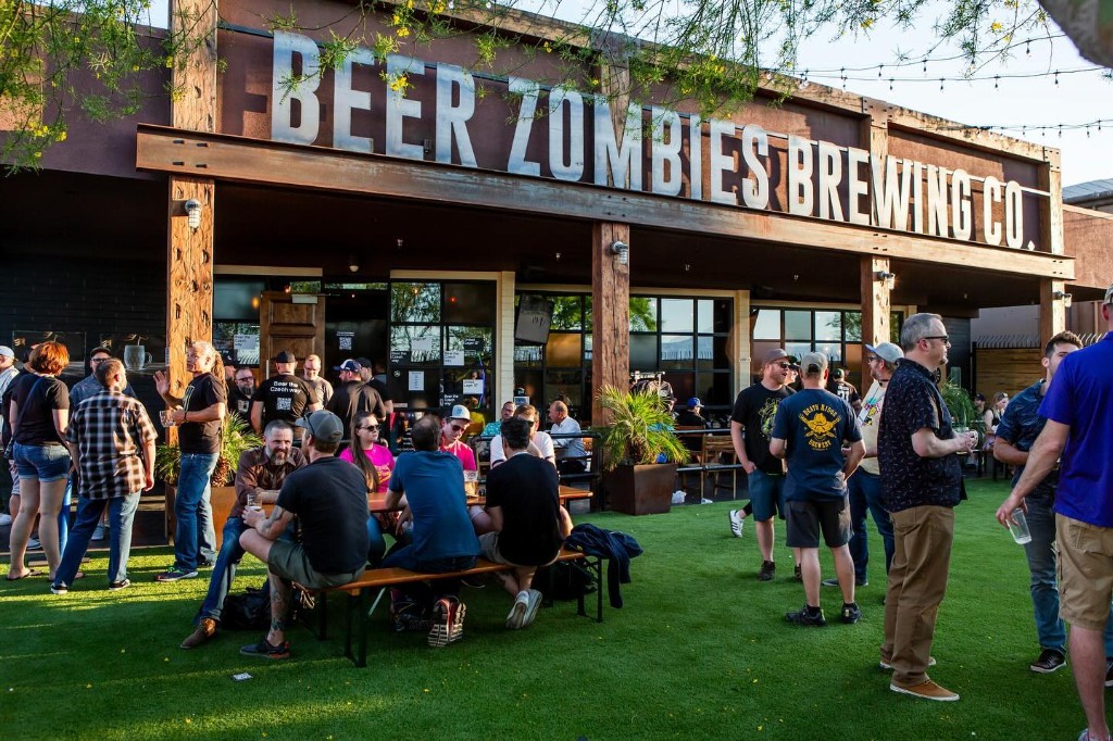 Crowd enjoying the turf patio outside the brewery on a sunny evening